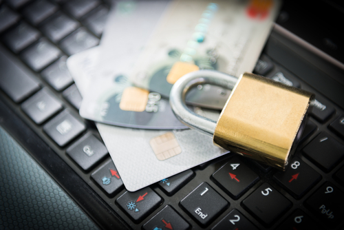 Padlock and credit cards on laptop